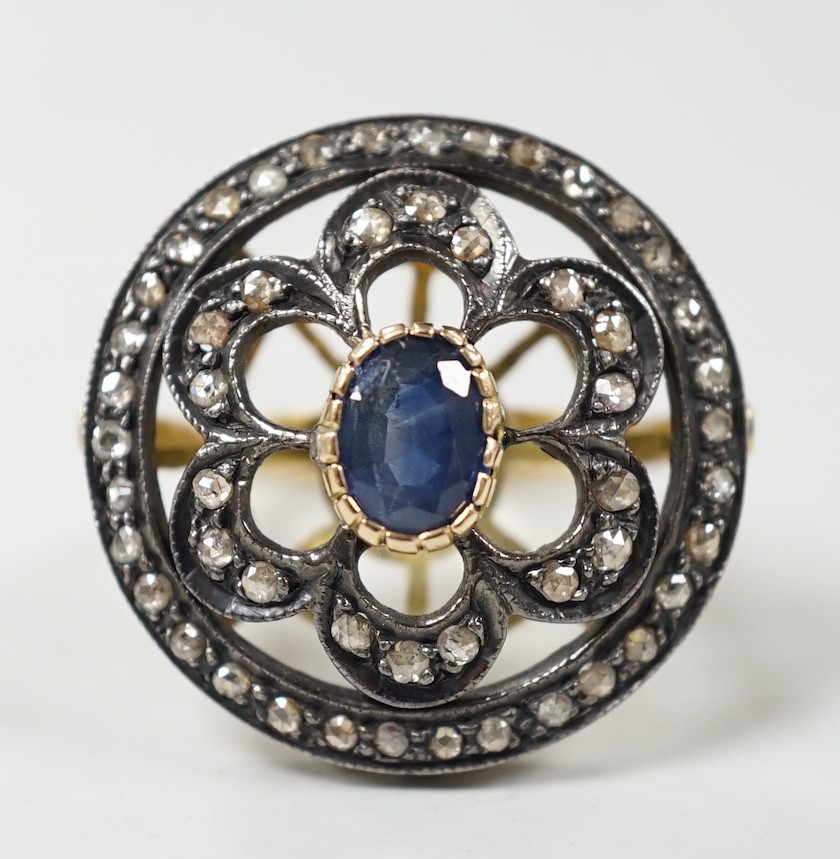An Indian pierced yellow metal, sapphire and rose cut diamond set circular cluster ring, size N/O, gross weight 8.4 grams.